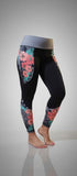 Women's hibiscus tights with island-inspired floral print, front smartphone pockets, and back zipper pocket in nylon spandex blend