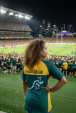 Woman wearing official Wallabies Greengold Jersey with Australia and kangaroo logo on back