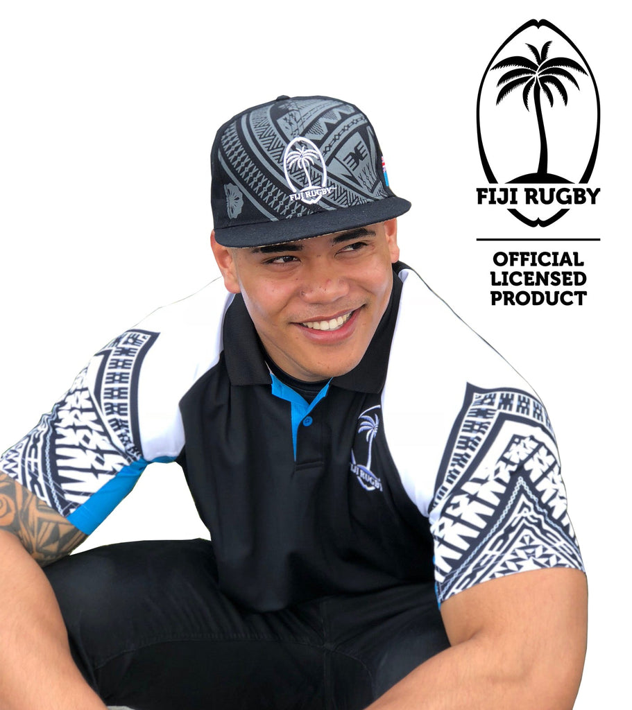 Man wearing official Fiji Rugby polo shirt and matching cap with tribal designs