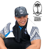 Man wearing official Fiji Rugby polo shirt and matching cap with tribal designs